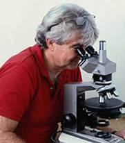 A person sitting at a table with microscope



Description generated with high confidence