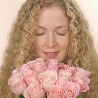 Woman Smelling Pink Roses